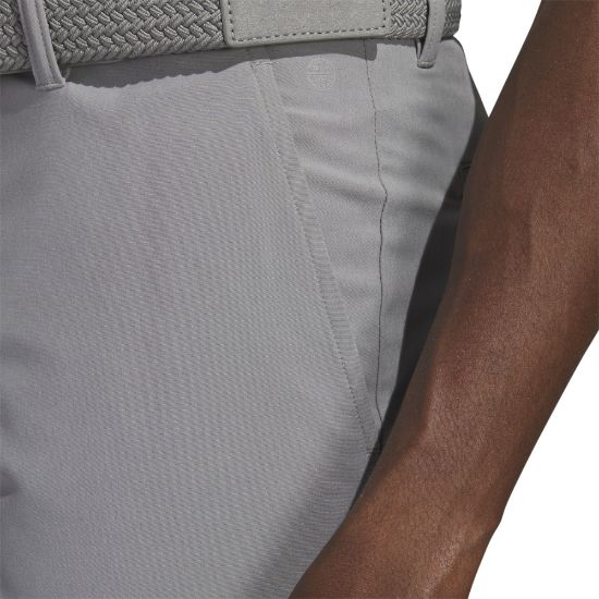 Model wearing adidas Men's Ultimate 365 Grey Three Golf Shorts Side View