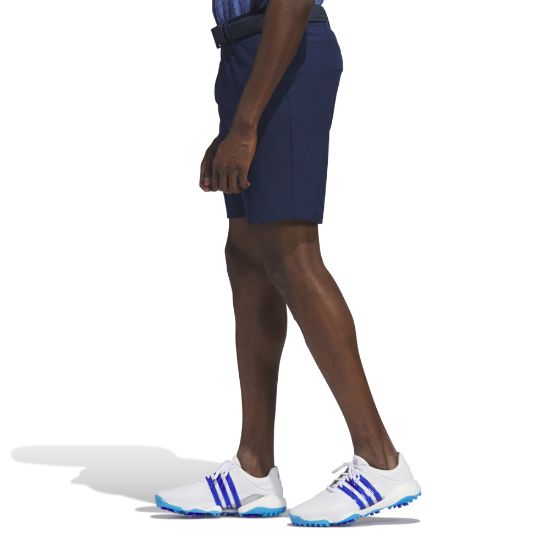 Model wearing adidas Men's Ultimate 365 Navy Golf Shorts Side View