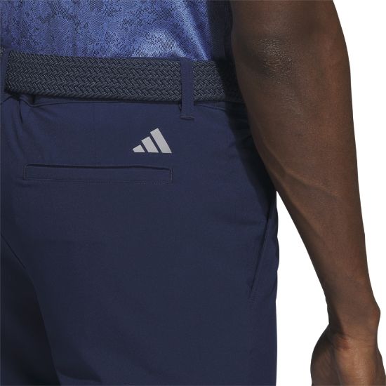 Model wearing adidas Men's Ultimate 365 Navy Golf Shorts Back View