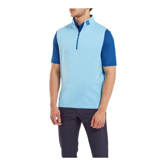 Model wearing FootJoy Men's 1/2 Zip Blue Sky Golf Vest