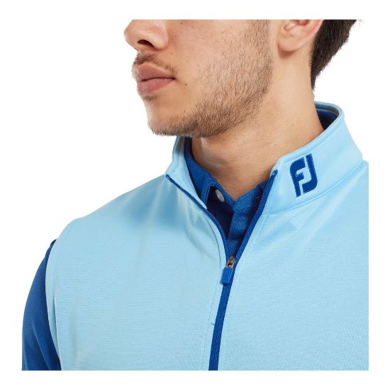 Model wearing FootJoy Men's 1/2 Zip Blue Sky Golf Vest Side View