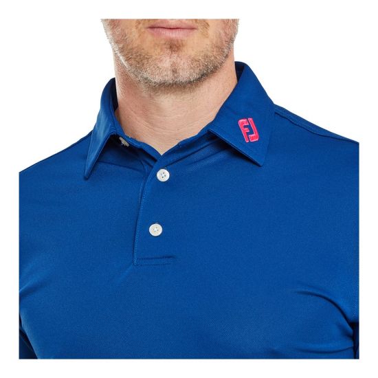 Model wearing FootJoy Men's Stretch Pique Solid Deep Blue Golf Polo Shirt Front View