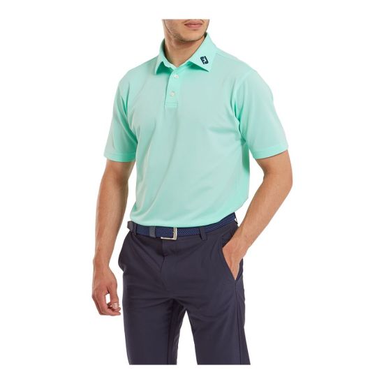Model wearing FootJoy Men's Stretch Pique Solid Sea Glass Golf Polo Shirt