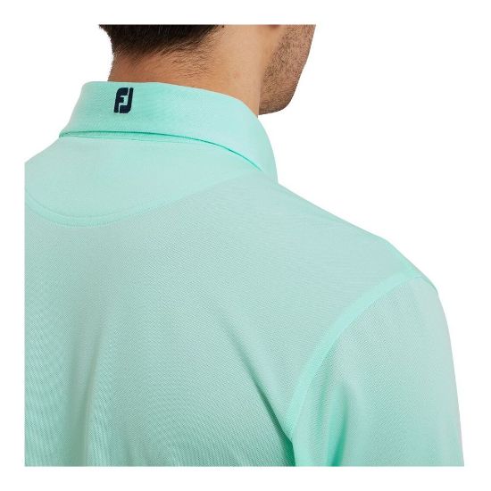 Model wearing FootJoy Men's Stretch Pique Solid Sea Glass Golf Polo Shirt Back