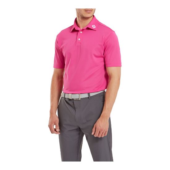 Model wearing FootJoy Men's Stretch Pique Solid Hot Pink Golf Polo Shirt