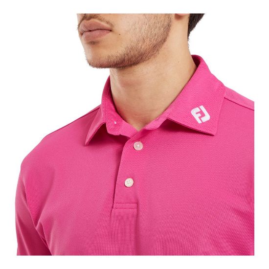 Model wearing FootJoy Men's Stretch Pique Solid Hot Pink Golf Polo Shirt Side View