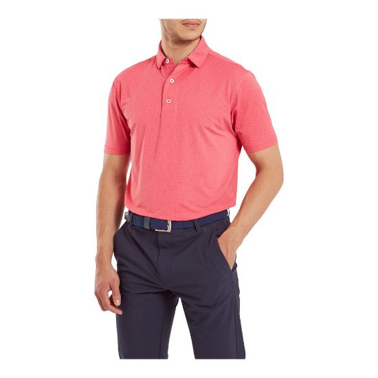 Model wearing FootJoy Men's Stretch Lisle Dot Print Coral Red/Navy Golf Polo Shirt