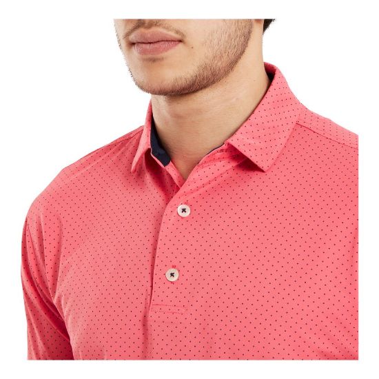 Model wearing FootJoy Men's Stretch Lisle Dot Print Coral Red/Navy Golf Polo Shirt Side View