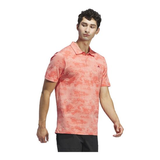 Model wearing adidas Men's Go To Print Mesh Preloved Scarlet Golf Polo Shirt Side View
