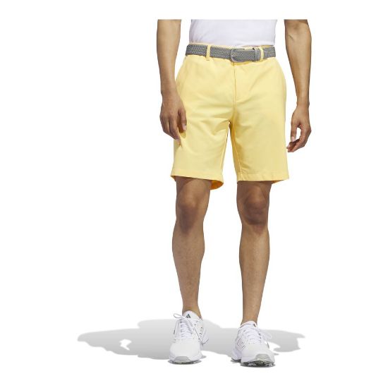 Model wearing adidas Men's Ultimate 365 Semi Spark Yellow Golf Short