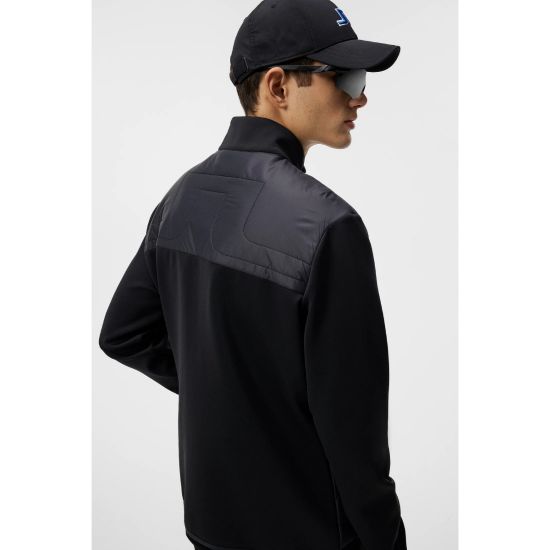 Model wearing J.Lindeberg Men's Martino Quilt Hybrid Black Golf Jacket Side View