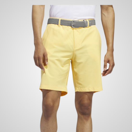 Model wearing adidas Men's Ultimate 365 Semi Spark Yellow Golf Shorts Front View